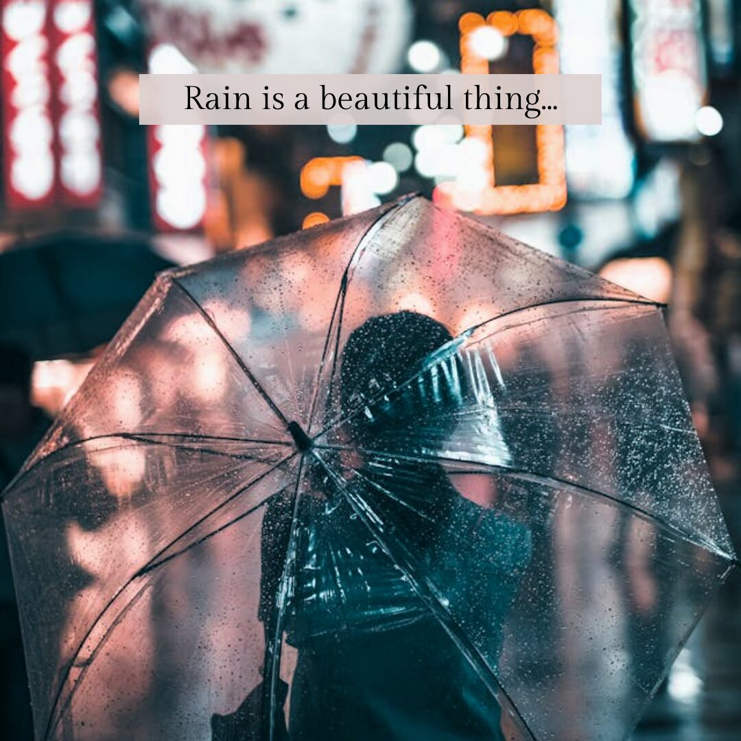 girl standing in the rain under an umbrella -30 Inspiring Rainy Day Quotes to Warm Your Soul