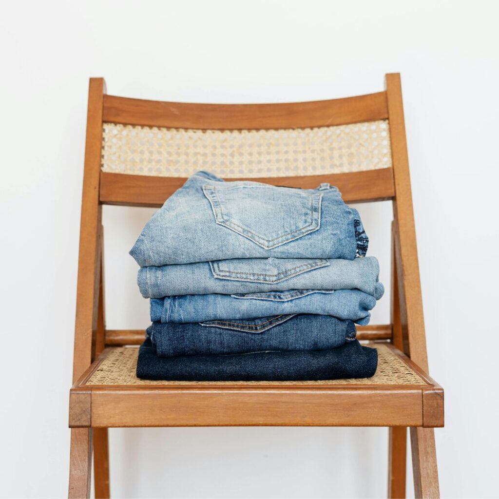 jeans folded on a chair -How to Organize Your Closet for the Transition to Fall Clothing A Simple 8 Step Guide