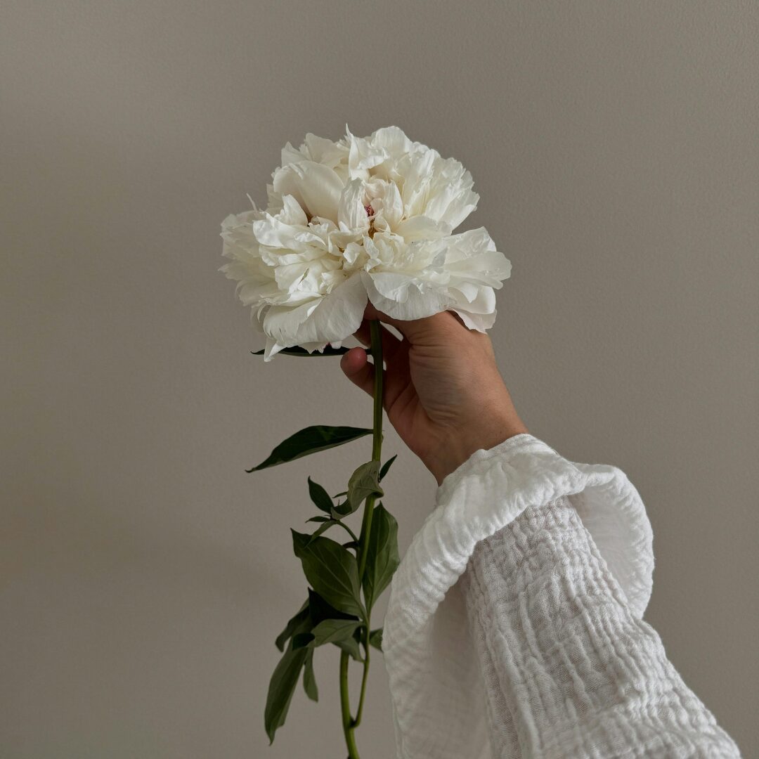 woman holding flowers -What is Feminine Energy 6 Powerful Ways to Activate it in Your Daily Life