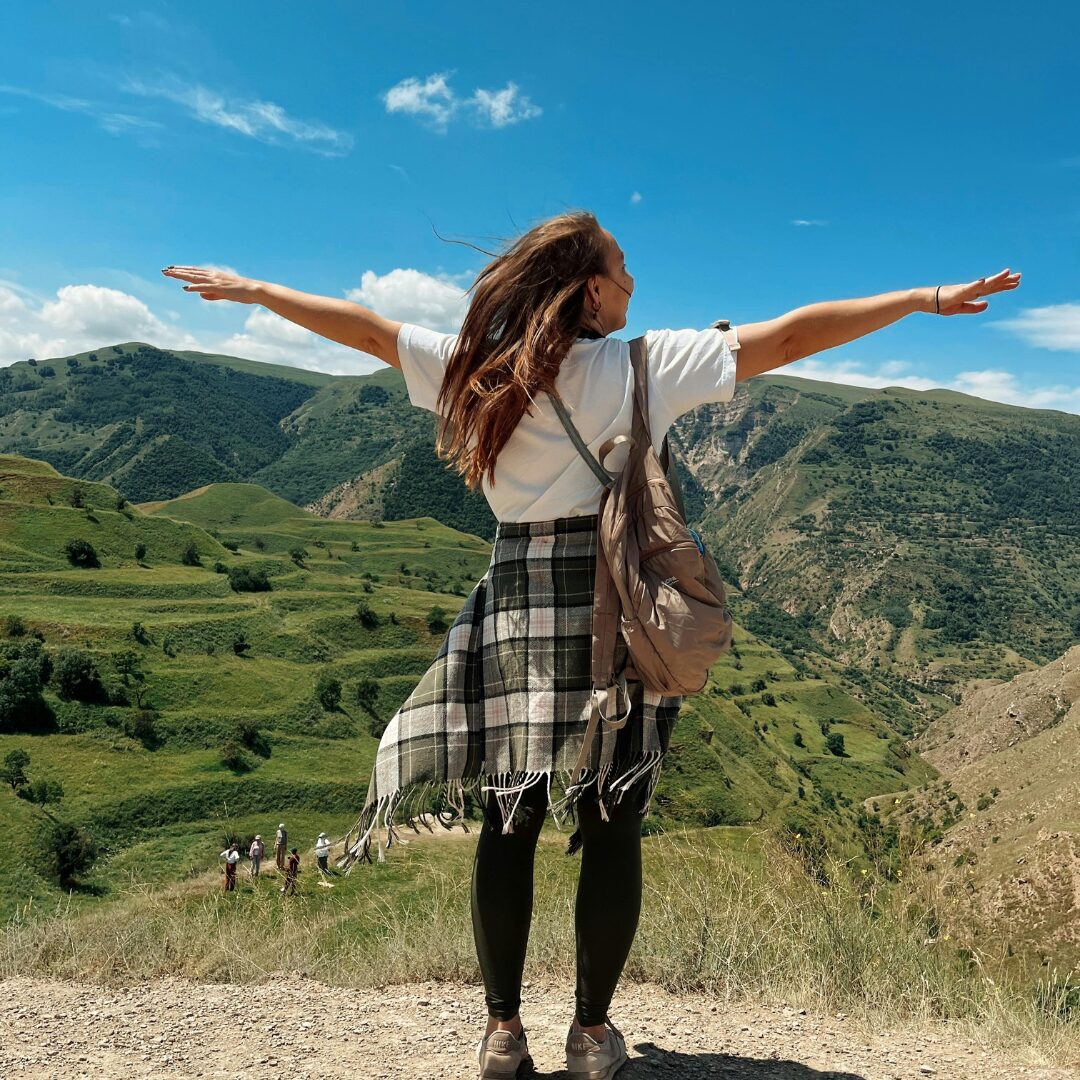 girl holding arms out on top of a mountain, 'freeing' and happy. -45 Uplifting Mental Health Quotes for on Your Saddest Days