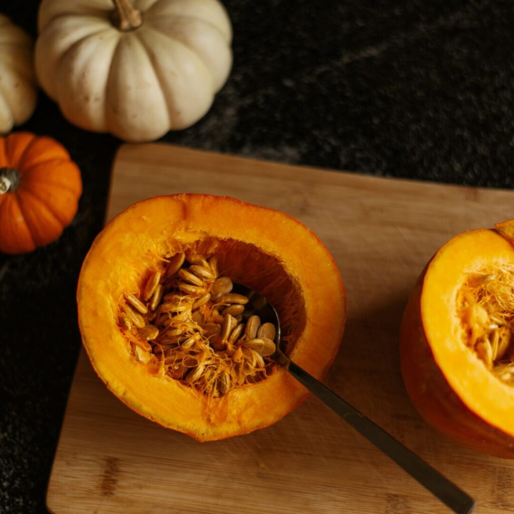 pumpkin cut in half - A Guide to Roasting Pumpkin Seeds and 5 Amazing Recipes