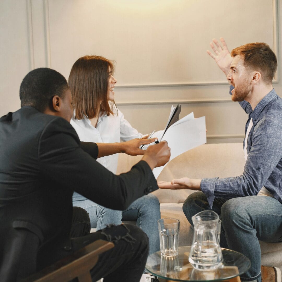 Couple Arguing While Sitting and Talking to a Man in a Suit at Home -10 Realistic Ways to Avoid Drama and Live a Peaceful Lifestyle