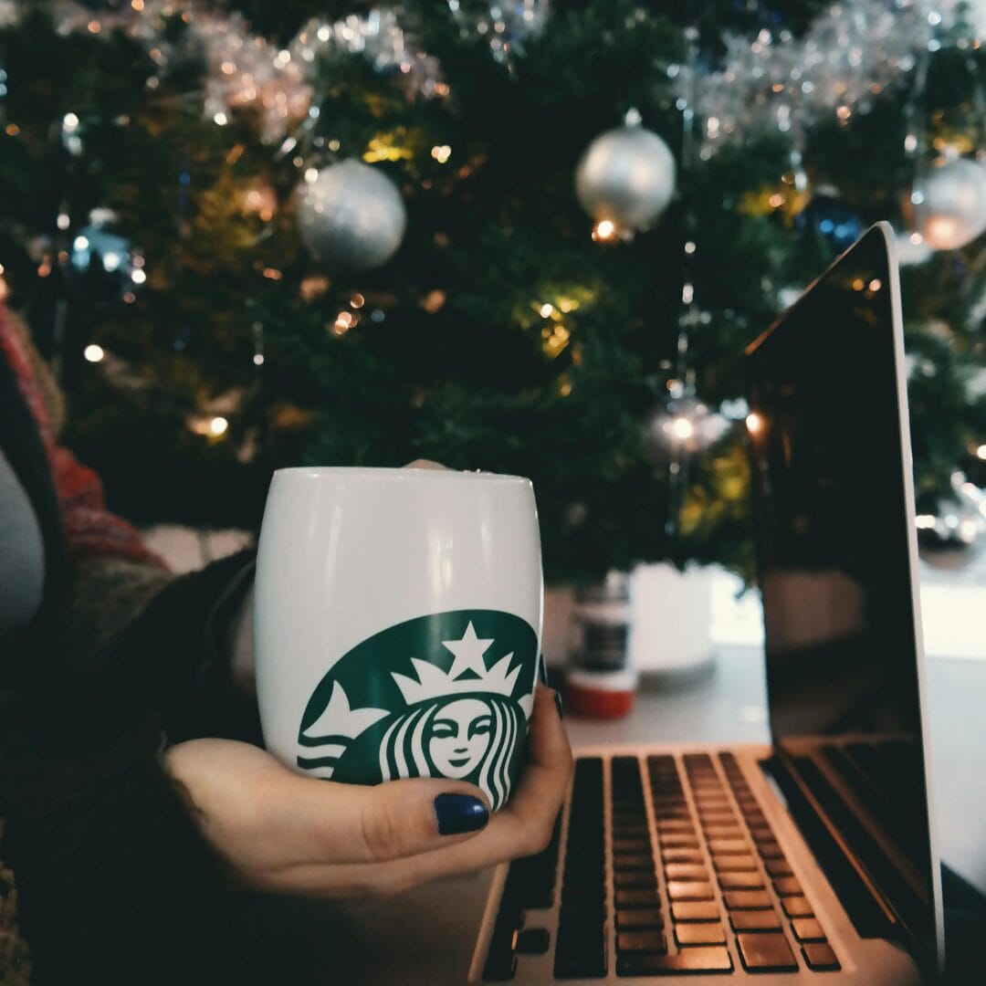 Person Holding Starbucks Mug -Adapting Your Morning Routine for Fall and Winter 10 Easy Ways to Keep Your Productivity High Year-Round